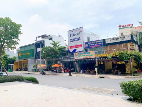 a city street with many shops and buildings at The Sun Avenue Serviced Apartment in Ho Chi Minh City