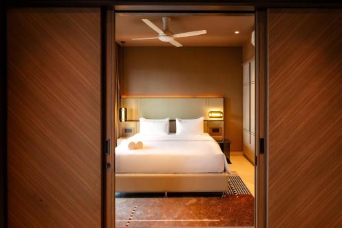 a bedroom with a bed and a ceiling fan at Antara Genting by Harvinton Mansion in Genting Highlands