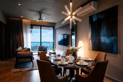 a living room with a dining room table and chairs at Antara Genting by Harvinton Mansion in Genting Highlands