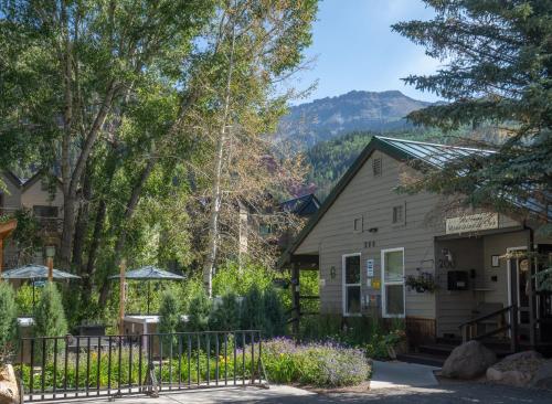 a building with a fence in front of it at Mountainside Inn 208 by Alpine Lodging Telluride in Telluride