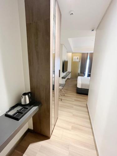a room with a stove and a room with a bed at Vibe Hotel Alabang in Manila