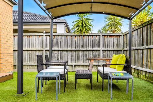 a gazebo with chairs and a table on a lawn at Modern 2BR Comfort in the Heart of Officer in Officer