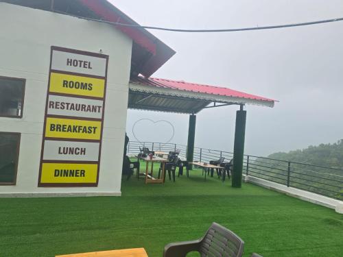 a hotel with a sign that says rooms restaurant breakfast and lunch at Hotel hr inn morni in Panchkula