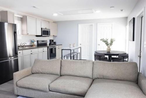 a living room with a couch and a kitchen at 5 Min to Elon - In Unit Washer and Dryer - Fast Wi-Fi in Burlington