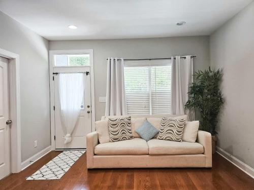 a living room with a couch and a window at Fire Pit - 4 Min from UNC - 7 Min from Carrboro - Fast Wi-Fi in Chapel Hill