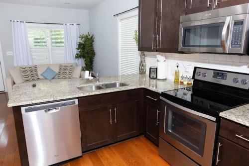 a kitchen with a sink and a stove top oven at Fire Pit - 4 Min from UNC - 7 Min from Carrboro - Fast Wi-Fi in Chapel Hill