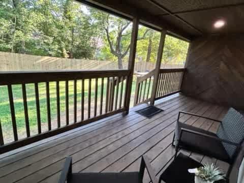 a screened in porch with a bench and chairs at 10 Min to Downtown - Smart Tvs - Fast Wi-Fi in Raleigh