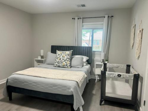a bedroom with a bed and a window at 10 Min to Downtown - Desk - Fenced Yard - Wi-Fi in Raleigh