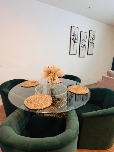 a dining room with a table and two green chairs at The Hollywood loft FREE Parking in Los Angeles