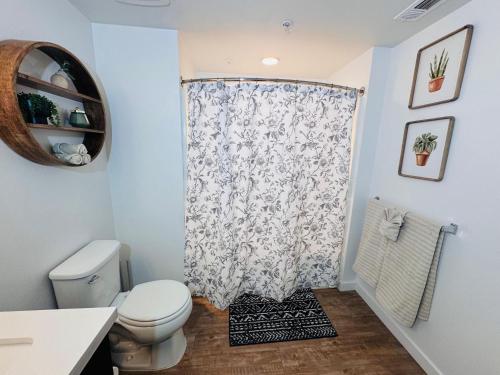 a bathroom with a toilet and a shower curtain at The Hollywood loft FREE Parking in Los Angeles