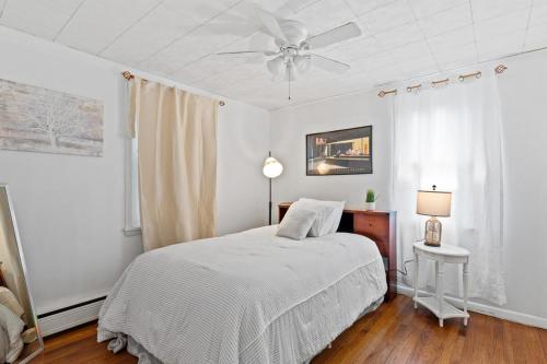 a bedroom with a bed and a ceiling fan at NEW " Fall Season " cozy 2 bed flat with open concept in Scranton