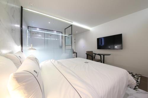 Ένα ή περισσότερα κρεβάτια σε δωμάτιο στο Avenue Hotel