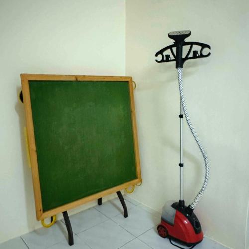 a green chalkboard with a toy car next to a black board at CYC homestay 18 pax in Kampong Batu Lapan