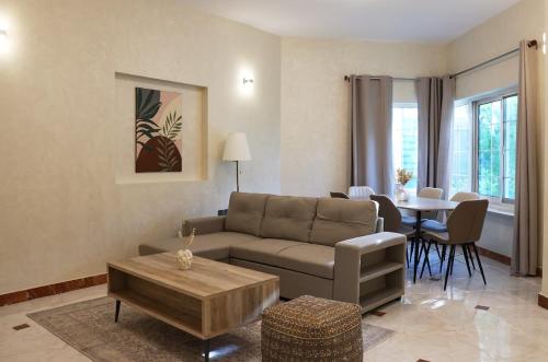 a living room with a couch and a table at Emirati Stay Comfort & Local Charm Villas - 3 in Dubai