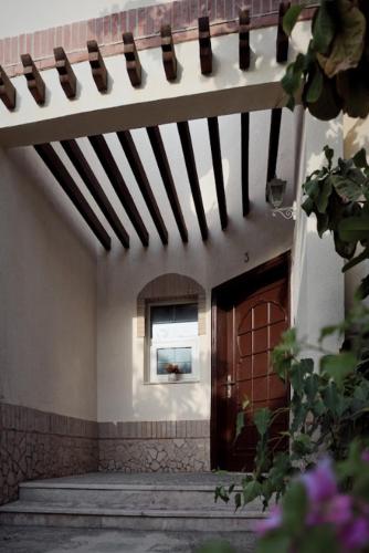 a hallway of a building with a door and a window at Emirati Stay Comfort & Local Charm Villas - 3 in Dubai