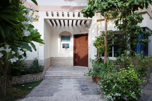 a entrance to a house with a wooden door at Emirati Stay Comfort & Local Charm Villas - 3 in Dubai