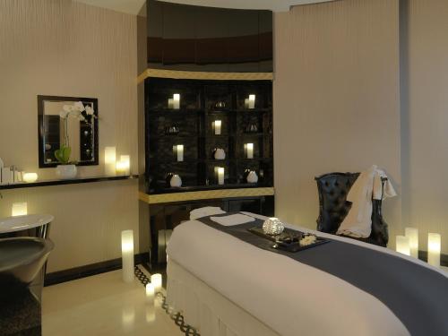 a room with a bed and a table and candles at DAMAC Maison Mall Street in Dubai