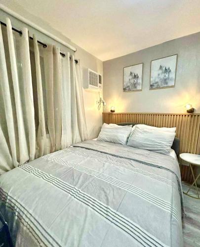 a bedroom with a large bed in front of the window at MyOneSpace4u at One Spatial Condo Hotel in Iloilo City