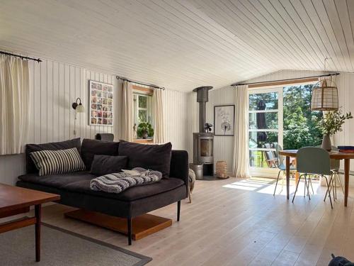 a living room with a couch and a table at Family-Friendly Holiday Home Near Skærby Beach in Nykøbing Sjælland
