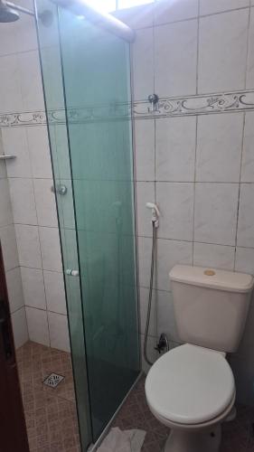 a bathroom with a toilet and a glass shower at Casa apartamento bem localizada cop30 in Belém