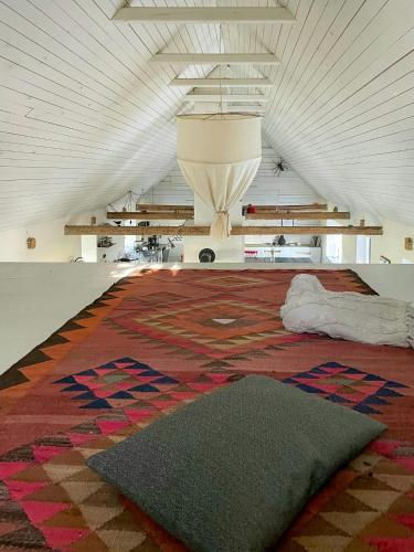 a large room with a large rug on the floor at Renovated Scanian Farmhouse With Two Studios in Skåne-Tranås