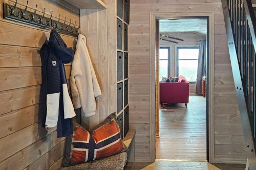 a hallway with a wall of wood paneling at New Cabin With Panoramic Views Of Lake Osen in Hektner