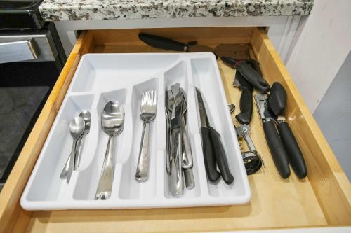 a tray with silver utensils on a table at CozySuites Stunning 1BR in Downtown Pitts 35 in Pittsburgh