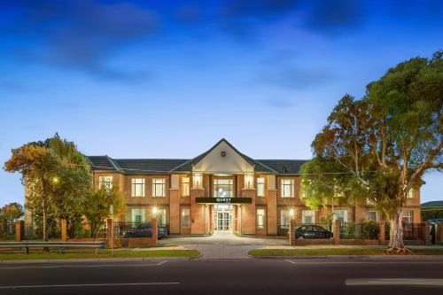 a large brick building on a street at Quest Dandenong in Dandenong