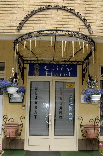 an entrance to a hotel with a sign above the door at City Hotel Siófok in Siófok