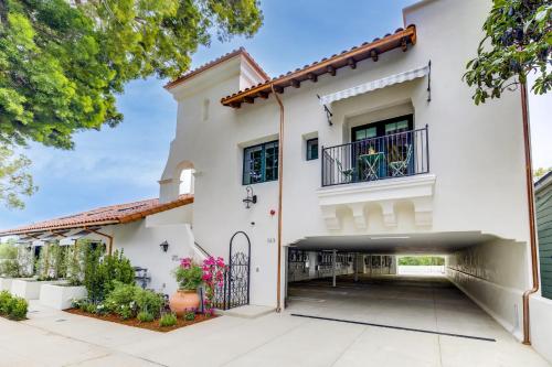 a white house with a courtyard and a balcony at Casa De La Vina - Boutique Suites in Downtown Santa Barbara in Santa Barbara