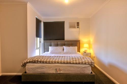 a small bedroom with a bed with a window at 42 Old Murbko Road in Morgan