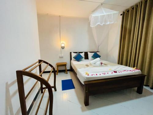 a small room with a bed and a chair at Sigiri Rew Haven in Sigiriya