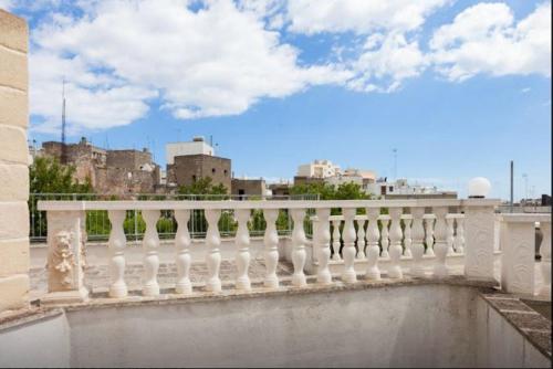 a white fence with a city in the background at Casa Vittorio Veneto in Carovigno