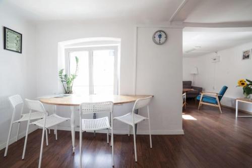 a dining room with a table and chairs and a living room at Apple Inn in Warsaw