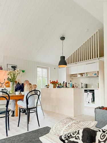 a kitchen and dining room with a table and chairs at Island Paradise Family-Friendly Near The Sea in Ljugarn
