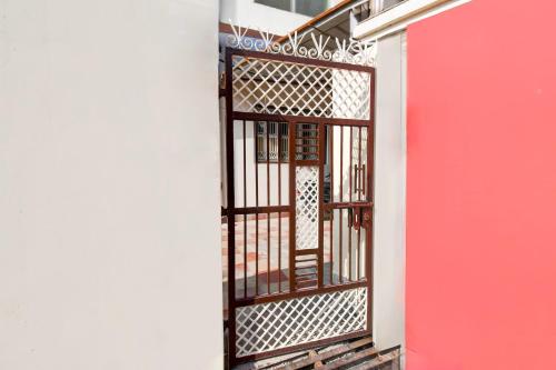 a gate in a building with a red door at Super Hotel O BHU Campus in Varanasi