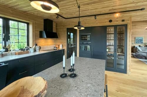 a kitchen with a counter top in a room at Mountain Cabin With Views Over Jämtland's Expanse in Storhågna