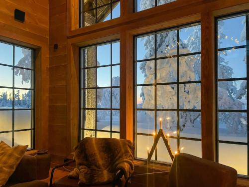 a living room with a christmas tree in the window at Mountain Cabin With Views Over Jämtland's Expanse in Storhågna