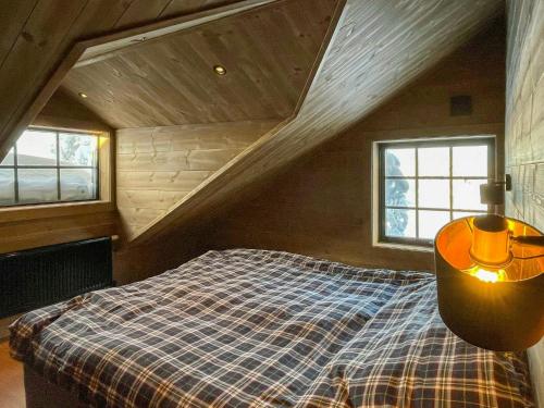 a bedroom with a bed in a attic at Mountain Cabin With Views Over Jämtland's Expanse in Storhågna