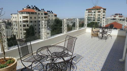 a group of chairs and tables on a balcony at Lavender Boutique Hotel in Ramallah