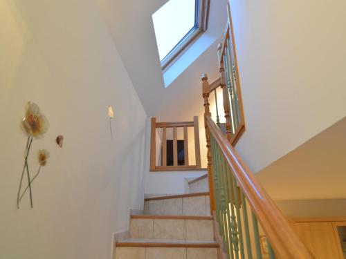 a staircase in a house with a window at Home for 7 Guests in Plouvara in Saint-Donan
