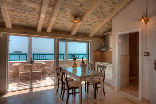 a dining room with a table and a view of the ocean at Piazza Apartments 1 in Petrovac na Moru