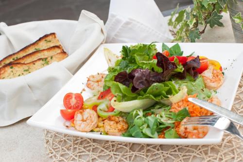 a plate of food with a salad and bread at Restaurant Gästehaus Wiesenheim in Uderns