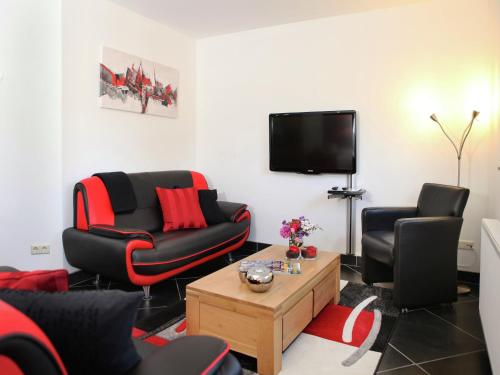a living room with two chairs and a tv at Holiday Home in Epen with Garden & BBQ in Epen