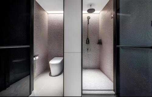 a bathroom with a shower and a toilet in it at IntercityHotel Shanghai South Xizang Road near Metro Station in Shanghai