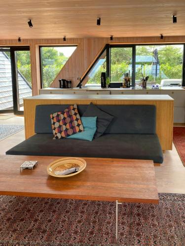 a living room with a couch and a coffee table at Architect-Designed A-House By Saksild Beach in Odder