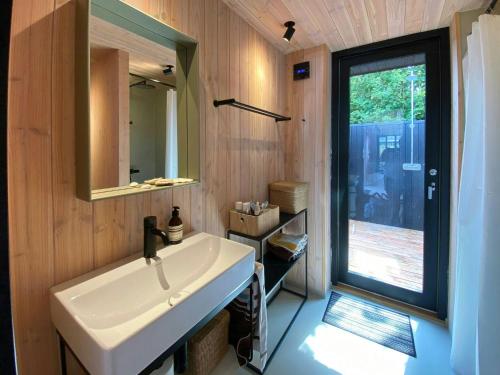 a bathroom with a sink and a mirror at Architect-Designed A-House By Saksild Beach in Odder