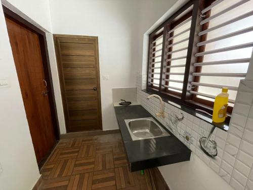 a small kitchen with a sink and a window at MISTY MOUNT VILLA MANANTHAVADY in Mananthavady