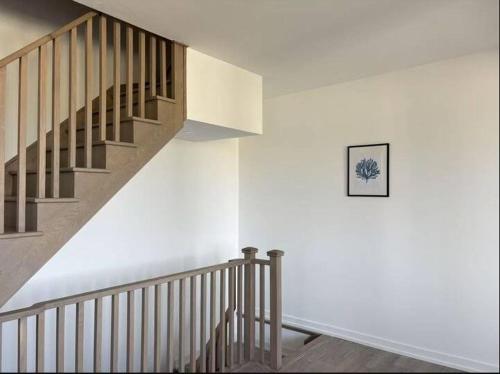 a staircase in a house with a picture on the wall at Cozy Room near Yorkdale in Toronto
