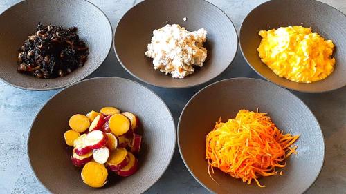 a group of bowls filled with different types of food at Marine Hotel Harimo in Hamada